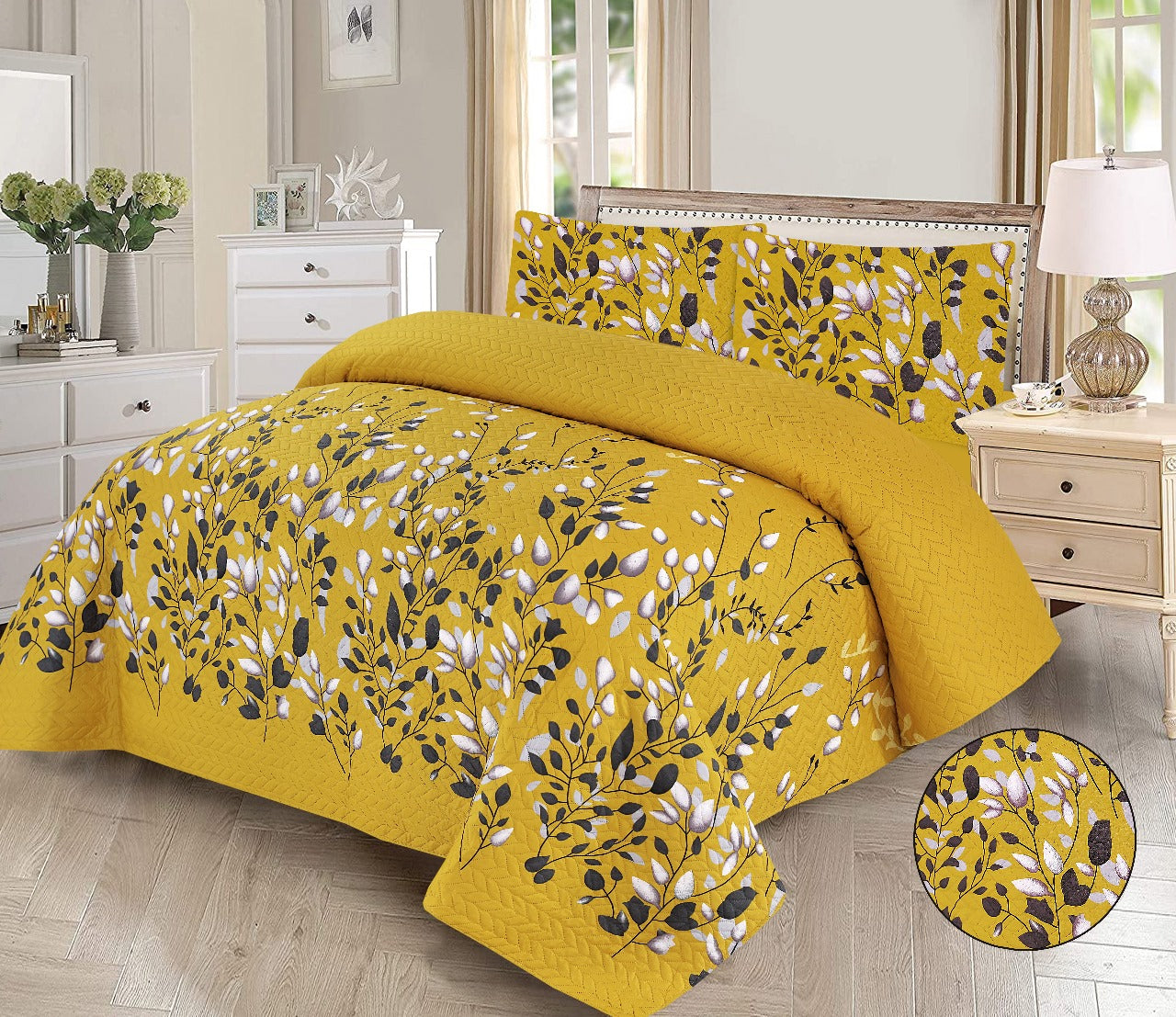 Yellow floral-patterned comforter set on a bed in a bedroom.