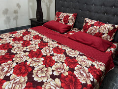 Floral patterned bedspread and pillows on a bed with a dark headboard.